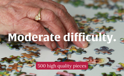 "Moderate difficulty" photo of an elderly woman's hand putting together a jigsaw puzzle.